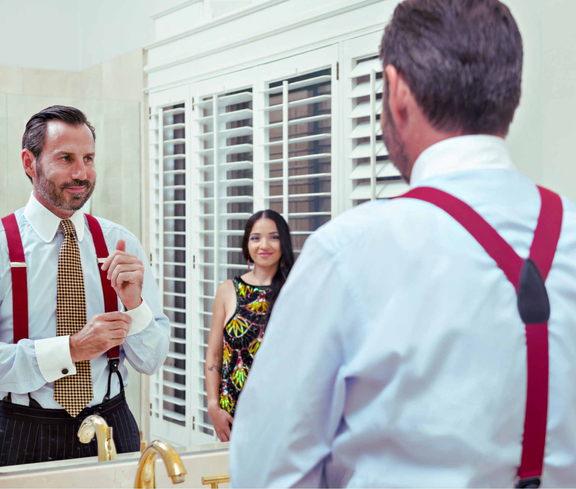 Man in mirror admired by wife