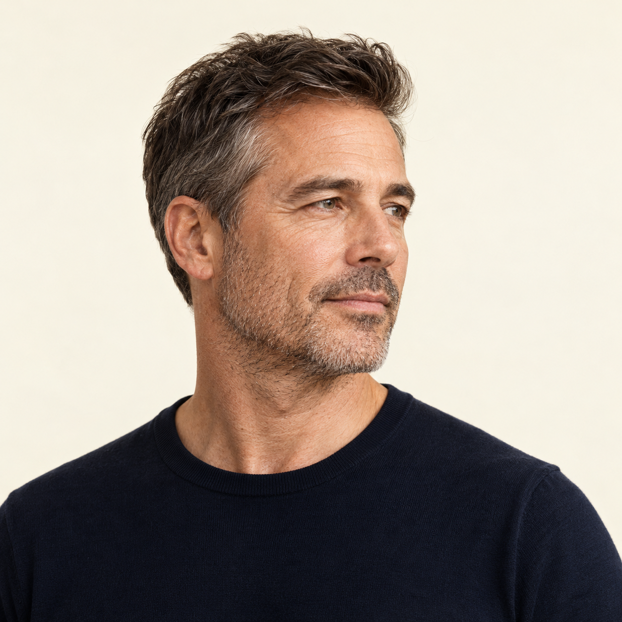 Three-quarter portrait of a middle-aged man showing natural jawline and neck contours.